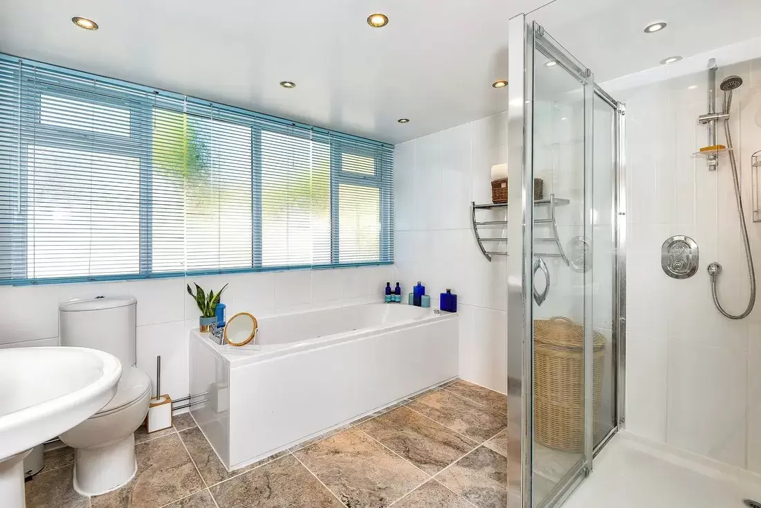 Large bathroom: Whirlpool bath, separate double shower cubicle, wash basin and WC.​